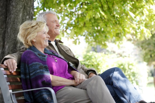 portrait of senior couple sitting on a bench